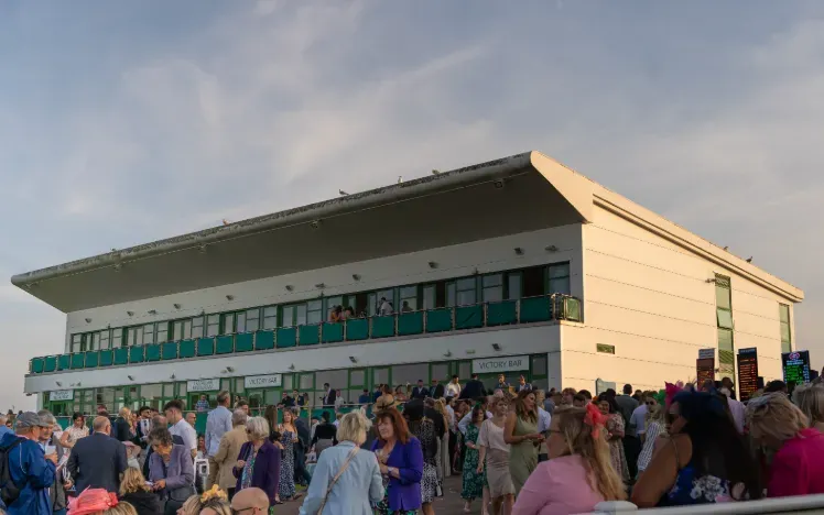 The grandstand and the crowds at Great Yarmouth at dusk